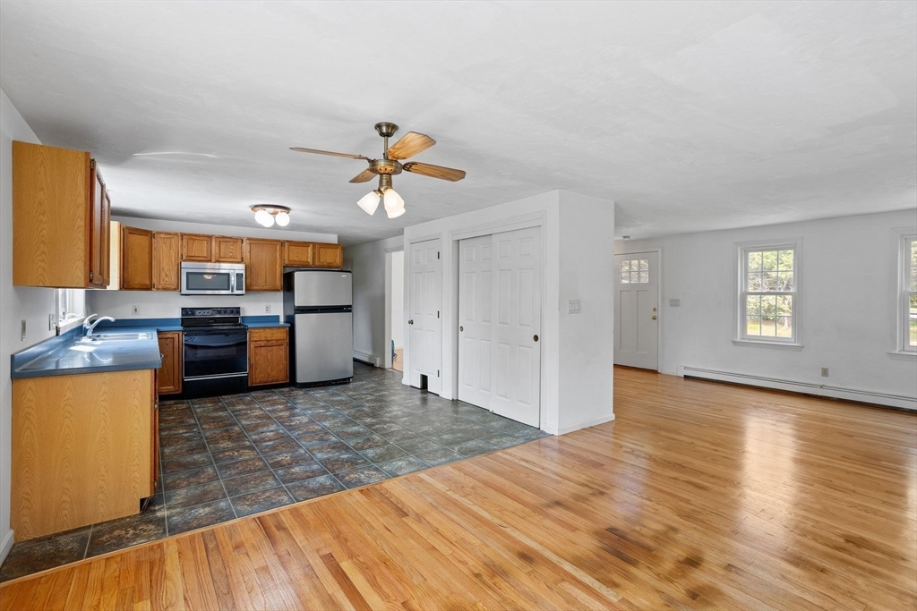 10 Farm Road Stow, MA 01775 - Photo 6 of 37 a view of a kitchen with furniture and wooden floor