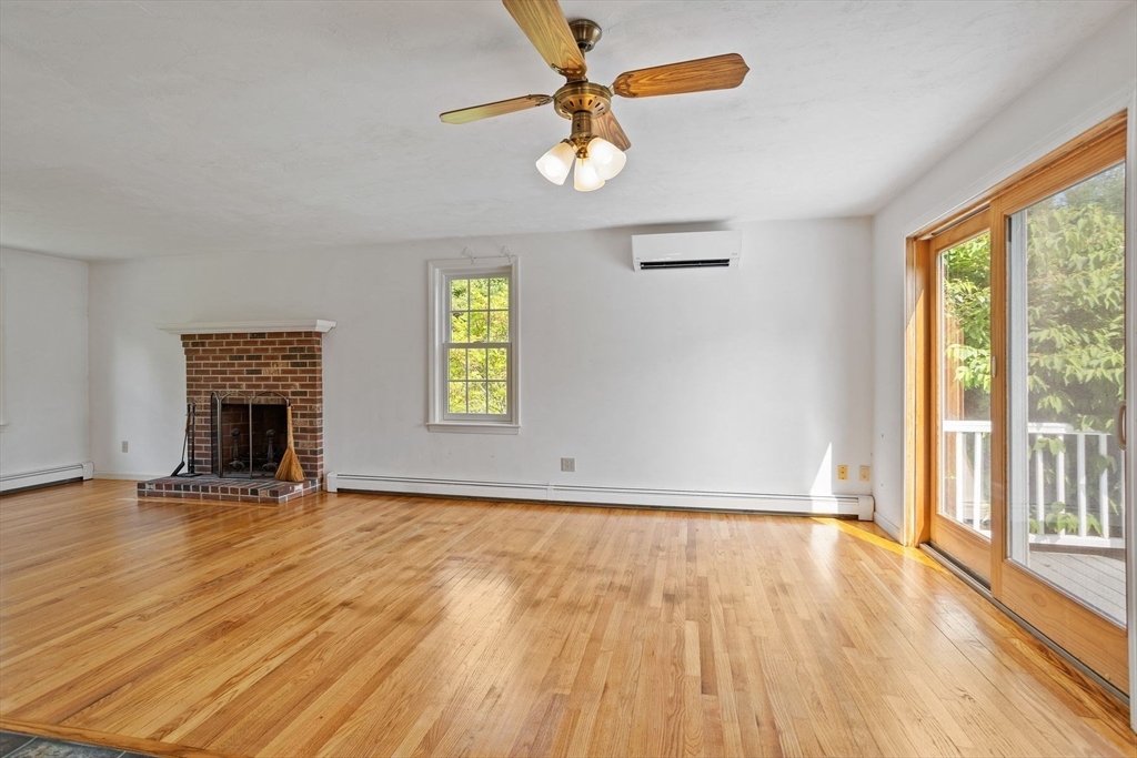 10 Farm Road Stow, MA 01775 - Photo 7 of 37 a view of an empty room with a window and wooden floor