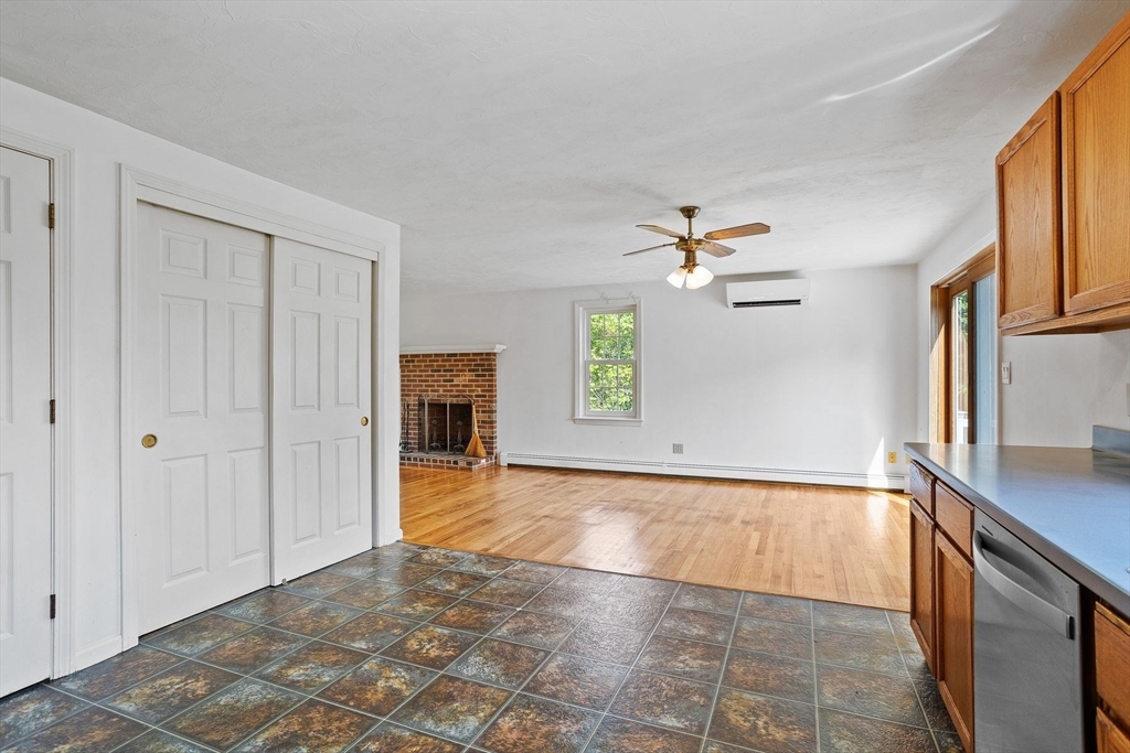 10 Farm Road Stow, MA 01775 - Photo 10 of 37 a view of a kitchen with wooden cabinet and a fireplace