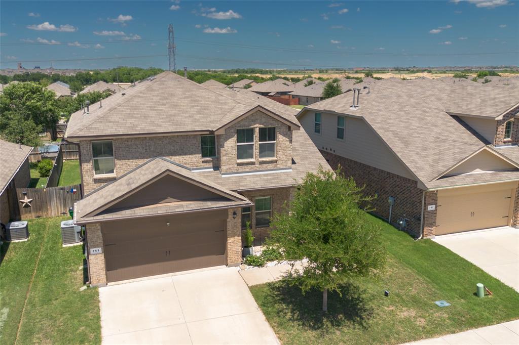 753 Rutherford Drive Crowley, TX 76036 - Photo 1 of 26 Two-story residence featuring a brick facade, attached two-car garage, and a concrete driveway