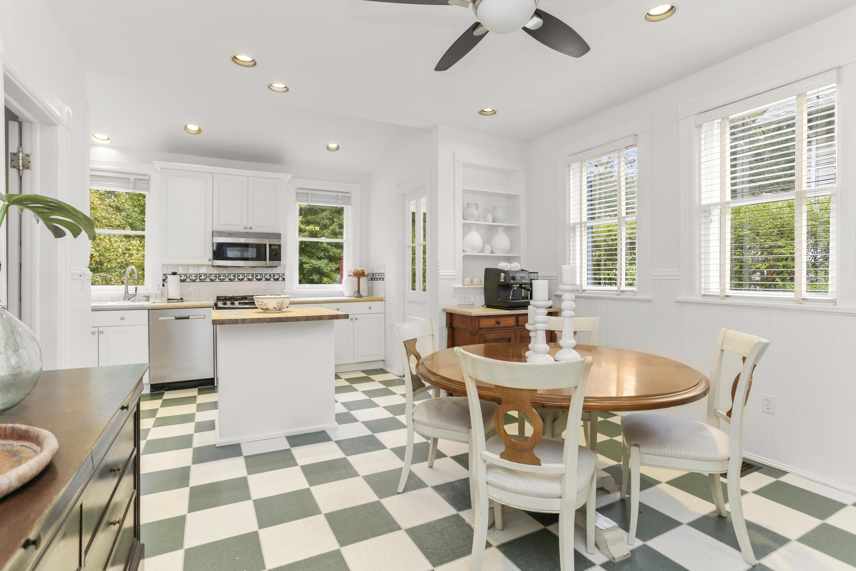 6 Park Lane Darien, CT 06820 - Photo 14 of 34 a kitchen with stainless steel appliances kitchen island granite countertop a sink a stove a dining table and chairs