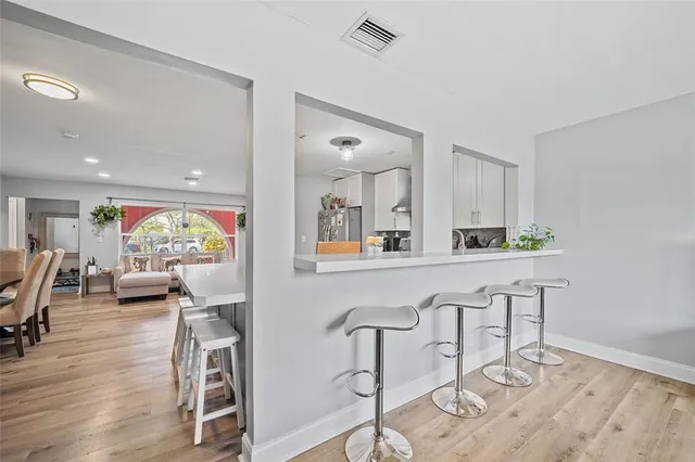 a view of kitchen with stainless steel appliances granite countertop cabinets and wooden floor