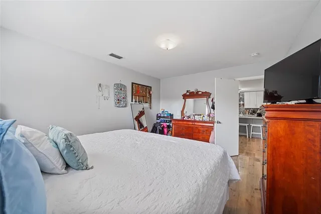 a bedroom with a bed and a flat screen tv