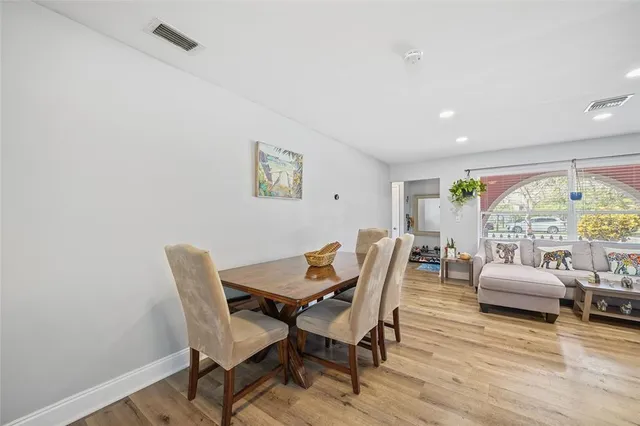 a dining room with furniture and a floor to ceiling window
