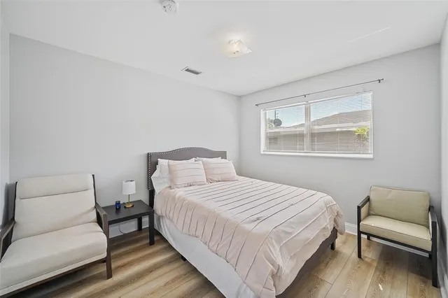 a bedroom with a bed and a couch