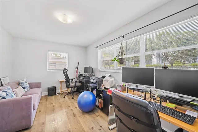 a view of a workspace with furniture and a window