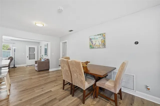 a dining room with furniture and wooden floor