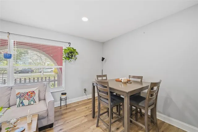 a view of a dining room with furniture window and wooden floor