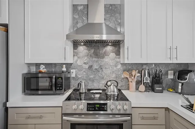 a kitchen with a stove and a white cabinets