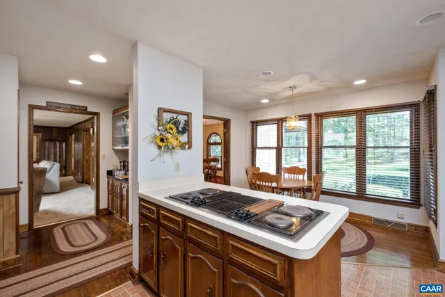 a kitchen with a refrigerator and a stove top oven
