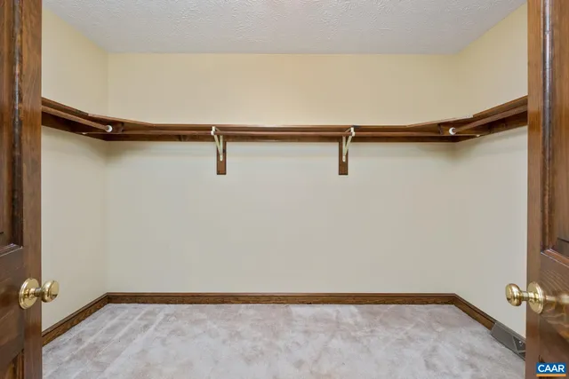 a spacious bathroom with a double vanity sink a mirror and a shower