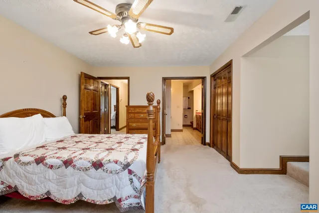 a bedroom with a bed and dresser with mirror
