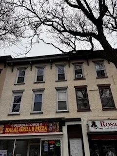 a front view of a building with many windows