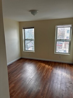 570 Main Street, Unit 3 Middletown, CT 06457 - Photo 2 of 8 an empty room with wooden floor and windows
