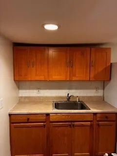 a view of a kitchen with sink and cabinets