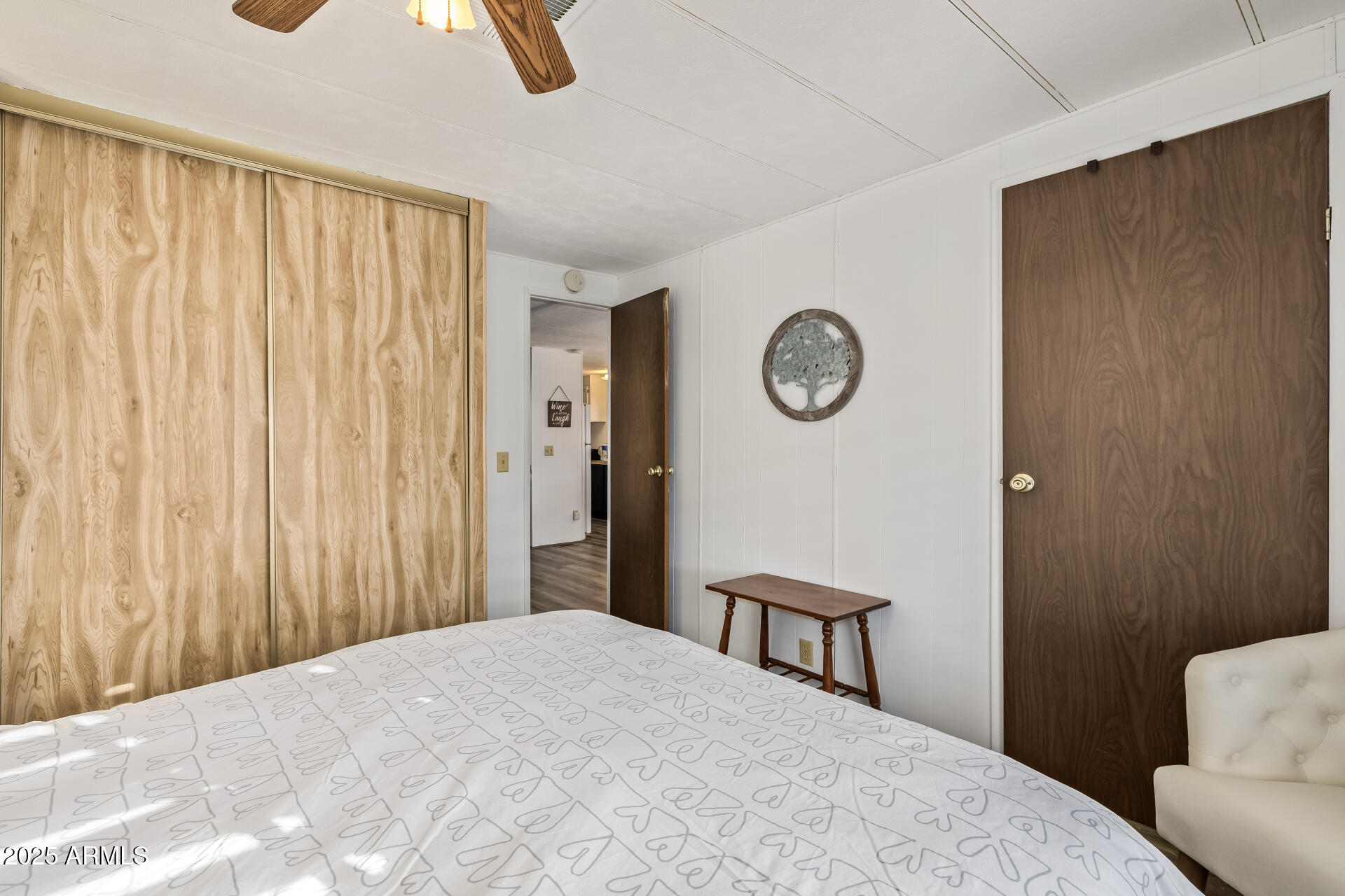 11425 East University Drive, Unit 120 Apache Junction, AZ 85120 - Photo 17 of 43 a bedroom with a bed and a lamp on the wall