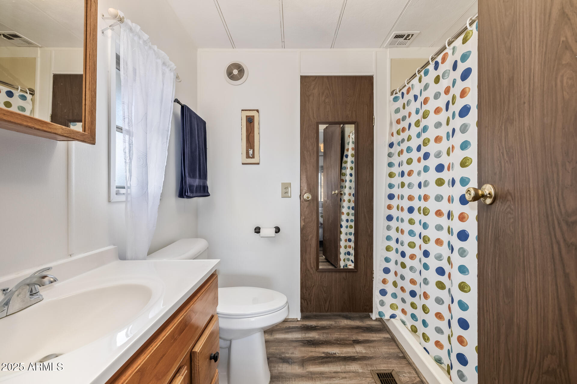 11425 East University Drive, Unit 120 Apache Junction, AZ 85120 - Photo 18 of 43 a bathroom with a sink and mirror with toilet