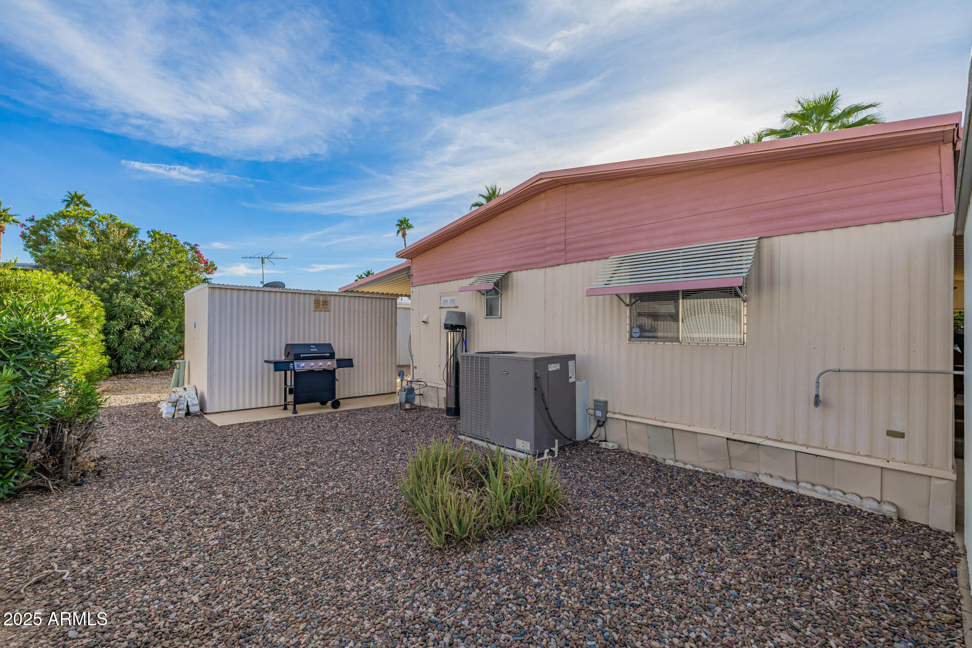 11425 East University Drive, Unit 120 Apache Junction, AZ 85120 - Photo 27 of 43 a backyard of a house with barbeque oven and outdoor seating
