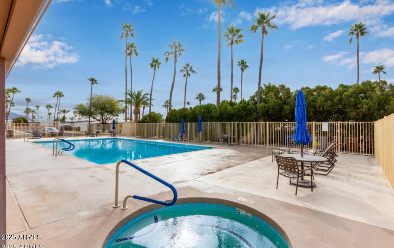 11425 East University Drive, Unit 120 Apache Junction, AZ 85120 - Photo 32 of 43 a view of a swimming pool with a lounge chairs