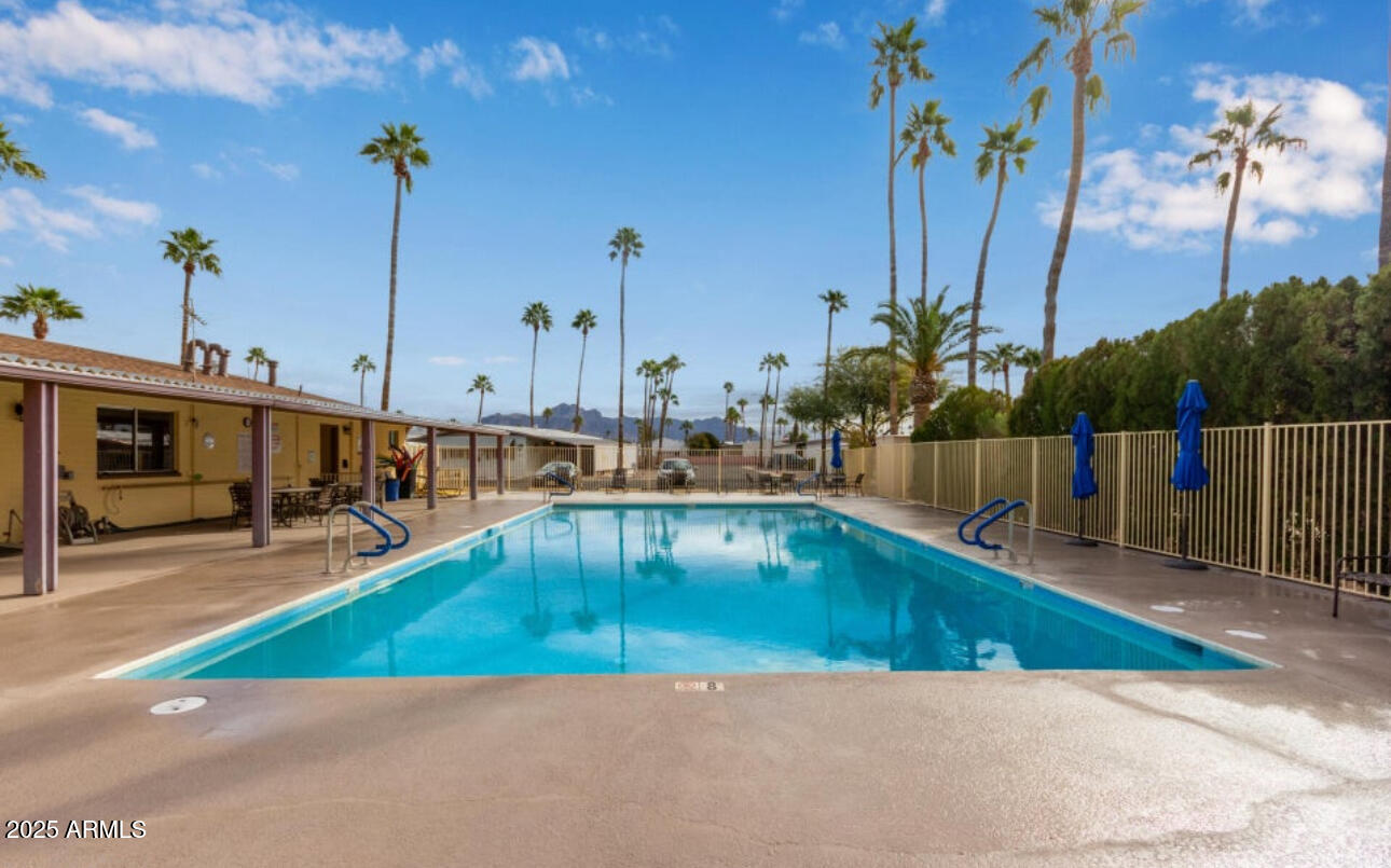 11425 East University Drive, Unit 120 Apache Junction, AZ 85120 - Photo 33 of 43 a view of a swimming pool with a lake view