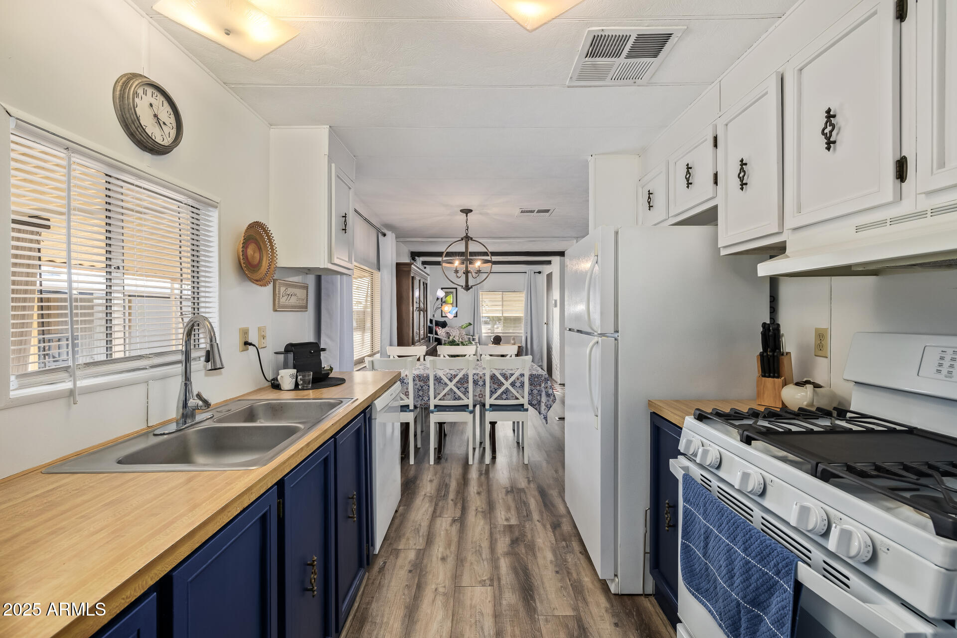 11425 East University Drive, Unit 120 Apache Junction, AZ 85120 - Photo 8 of 43 a kitchen with stainless steel appliances granite countertop a sink stove and refrigerator