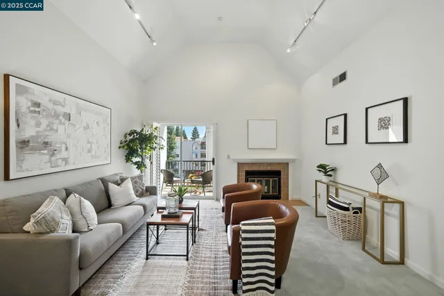 a living room with furniture a fireplace and a painting on the wall