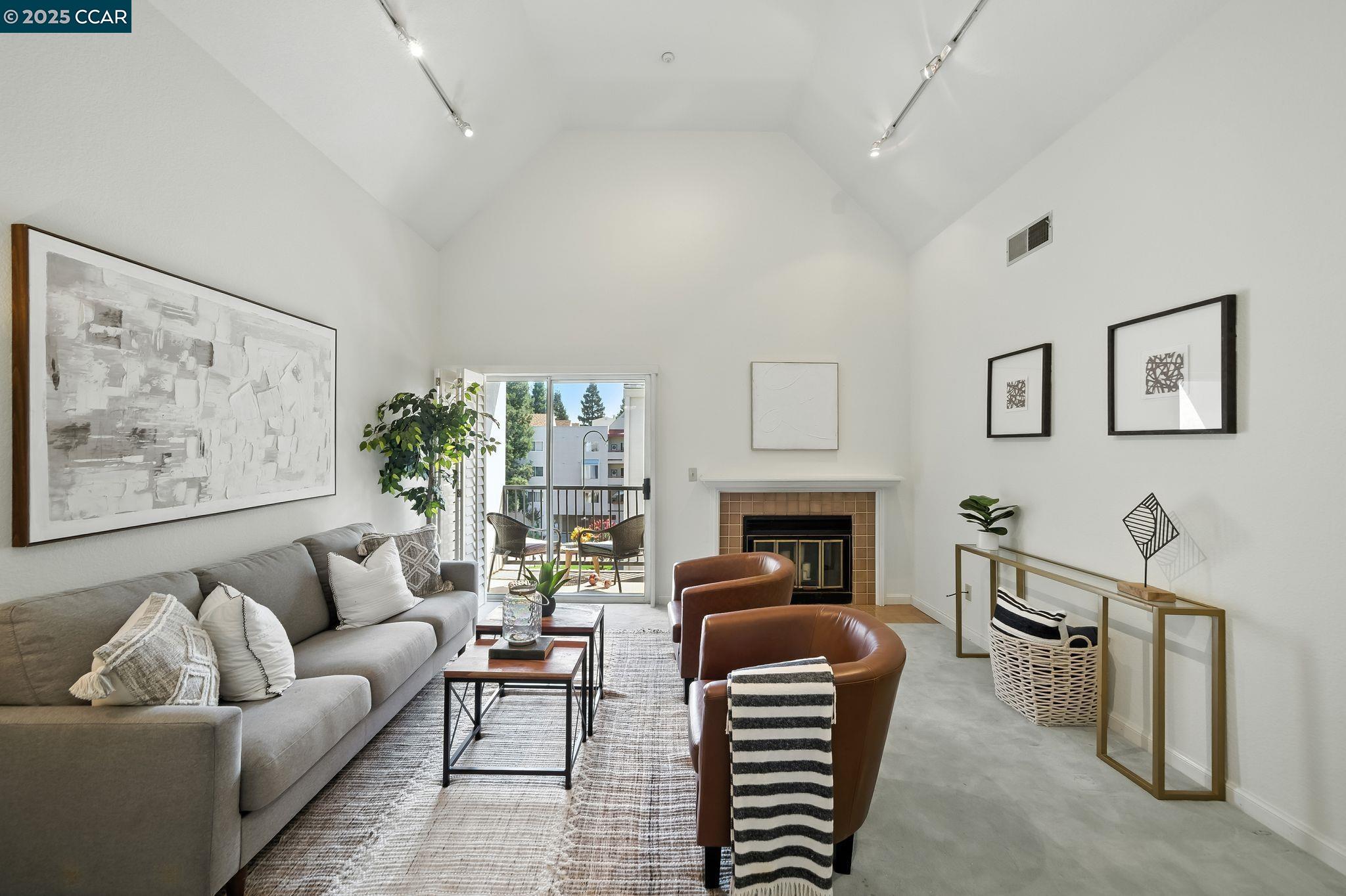 3183 Wayside Plaza, Unit 320 Walnut Creek, CA 94597 - Photo 1 of 34 a living room with furniture a fireplace and a painting on the wall