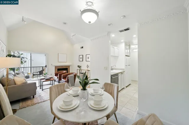 a living room with furniture a fireplace and a dining table