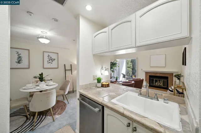 a kitchen with stainless steel appliances granite countertop a sink and cabinets
