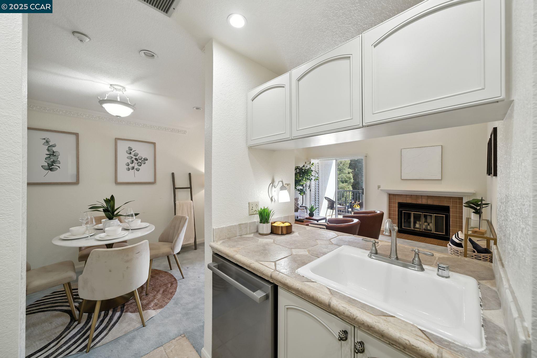 3183 Wayside Plaza, Unit 320 Walnut Creek, CA 94597 - Photo 14 of 34 a kitchen with stainless steel appliances granite countertop a sink and cabinets