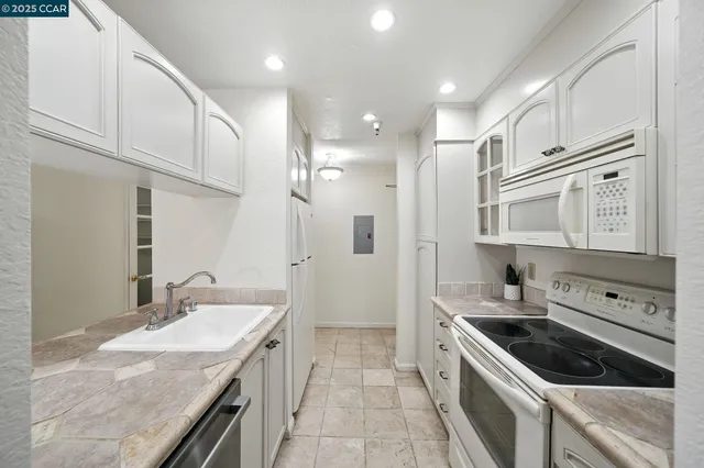 a kitchen with stainless steel appliances granite countertop a sink and cabinets