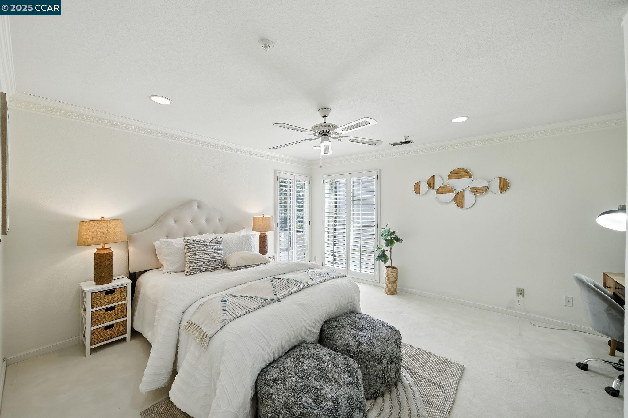 3183 Wayside Plaza, Unit 320 Walnut Creek, CA 94597 - Photo 16 of 34 a bed room with a bed and a chandelier