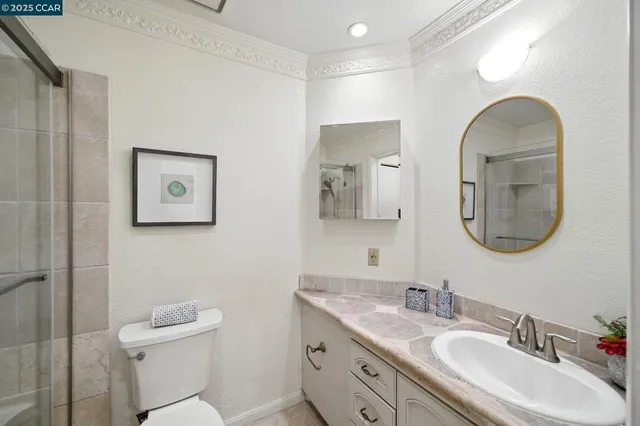 a bathroom with a toilet a sink and mirror