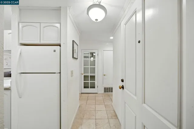 a view of a hallway with closet and front door