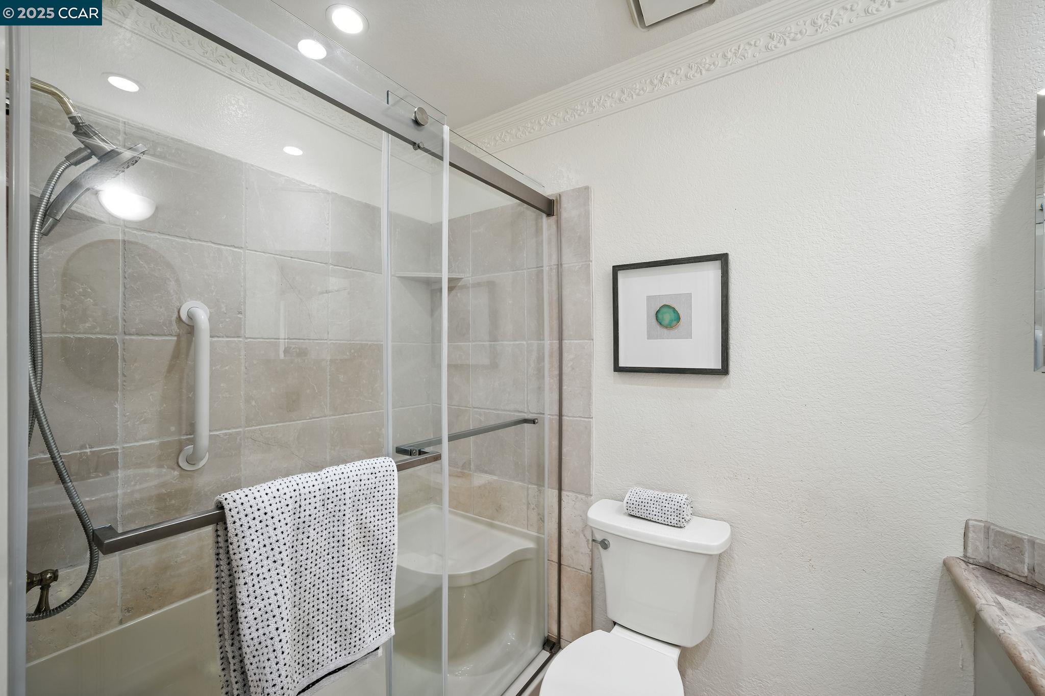 3183 Wayside Plaza, Unit 320 Walnut Creek, CA 94597 - Photo 21 of 34 a bathroom with a toilet sink and shower