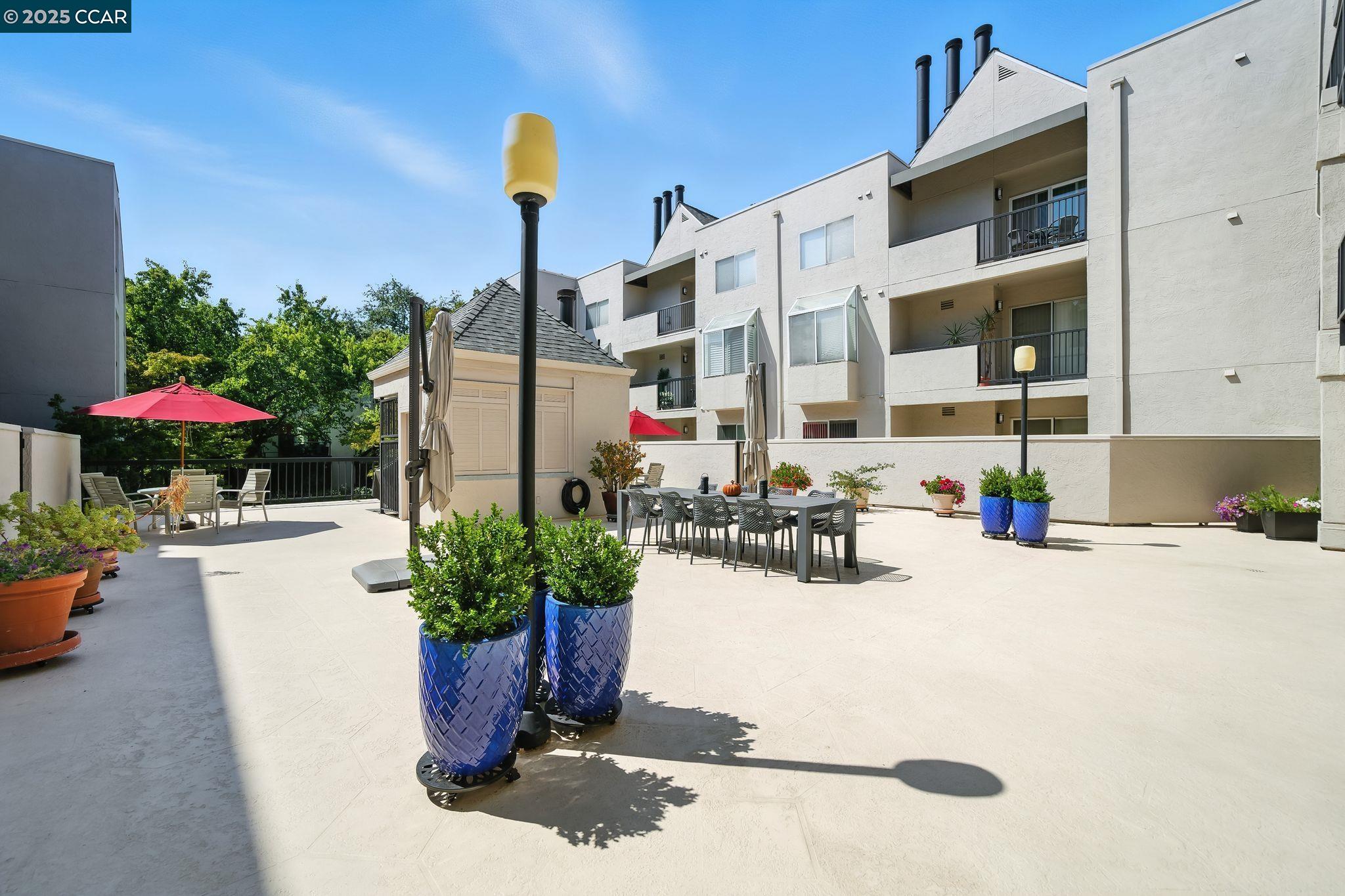 3183 Wayside Plaza, Unit 320 Walnut Creek, CA 94597 - Photo 25 of 34 a dining table with chairs and potted plants
