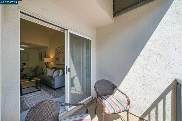 a living room with furniture and a chair