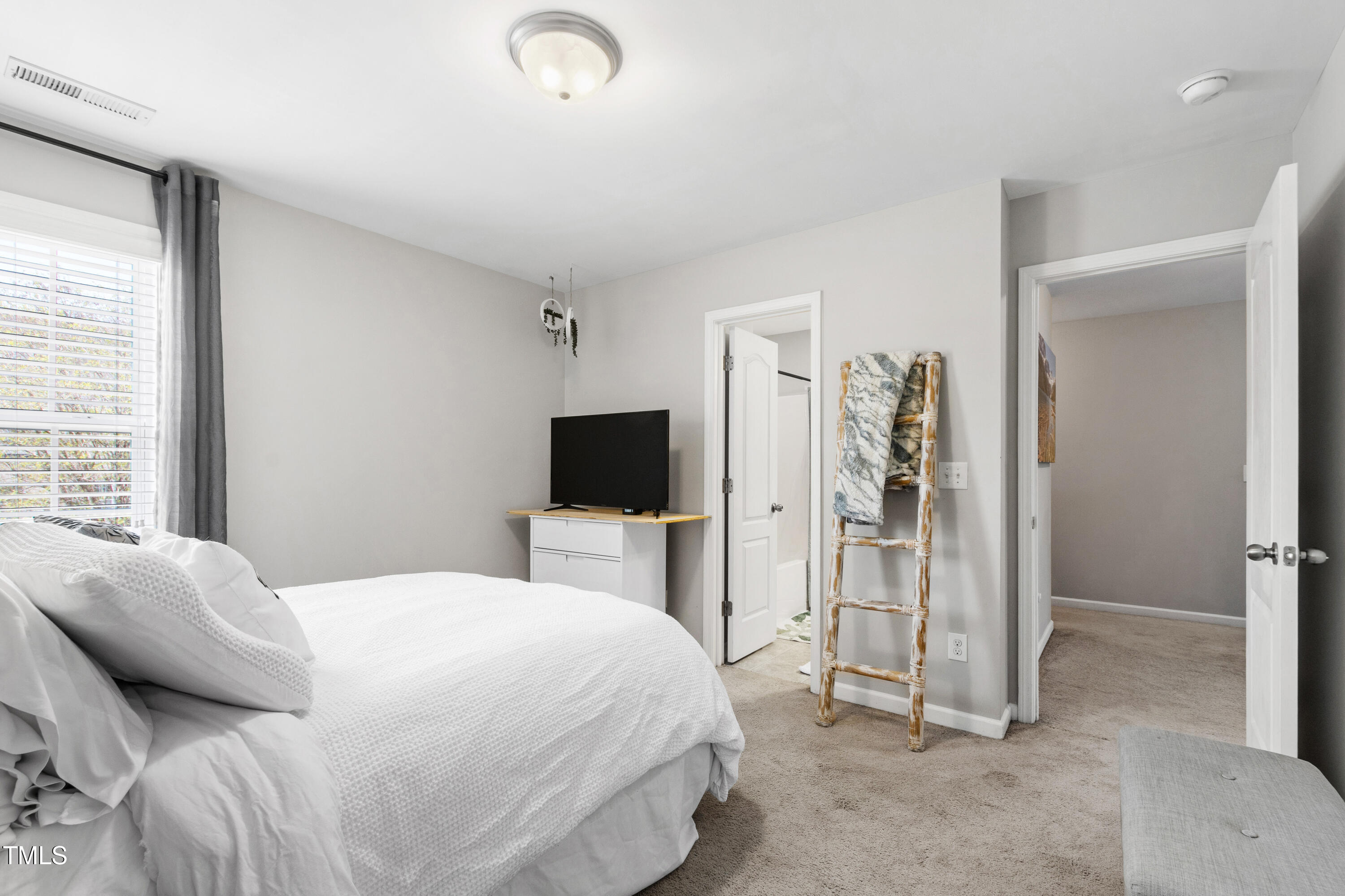 1322 Regulator Street Raleigh, NC 27603 - Photo 40 of 58 a bedroom with a bed and a flat screen tv