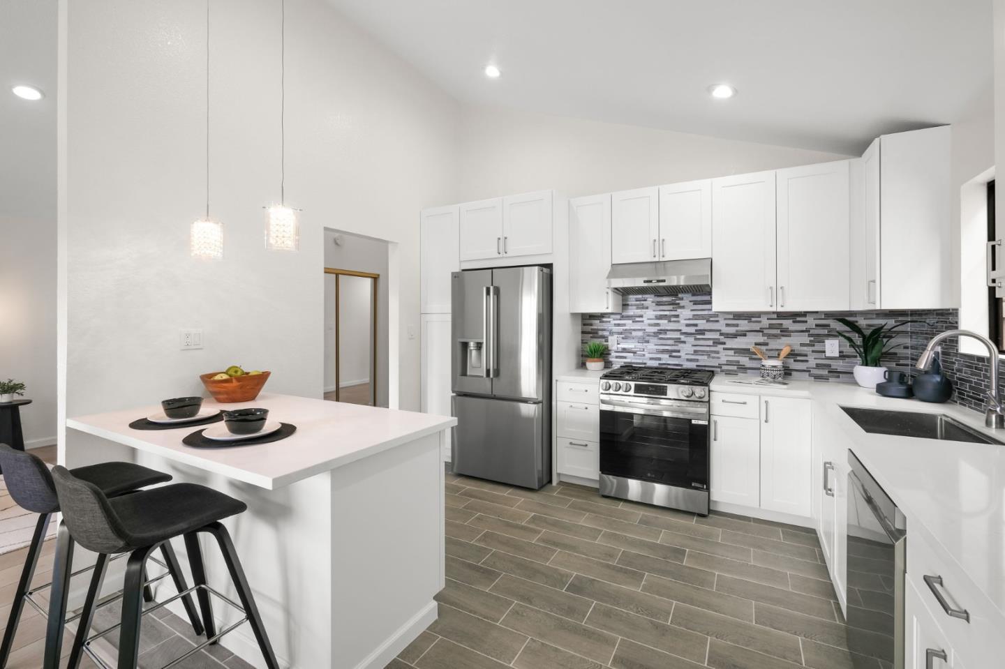 415 C Street Colma, CA 94014 - Photo 19 of 57 a kitchen with a stove a refrigerator and a dining table