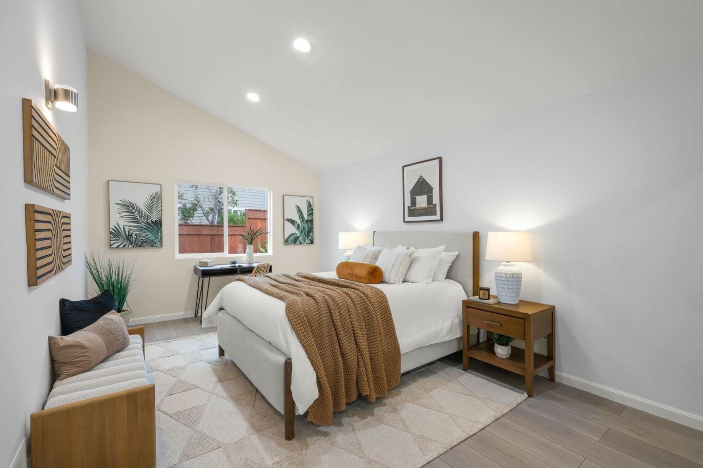 415 C Street Colma, CA 94014 - Photo 23 of 57 a spacious bedroom with a bed a couch and a window