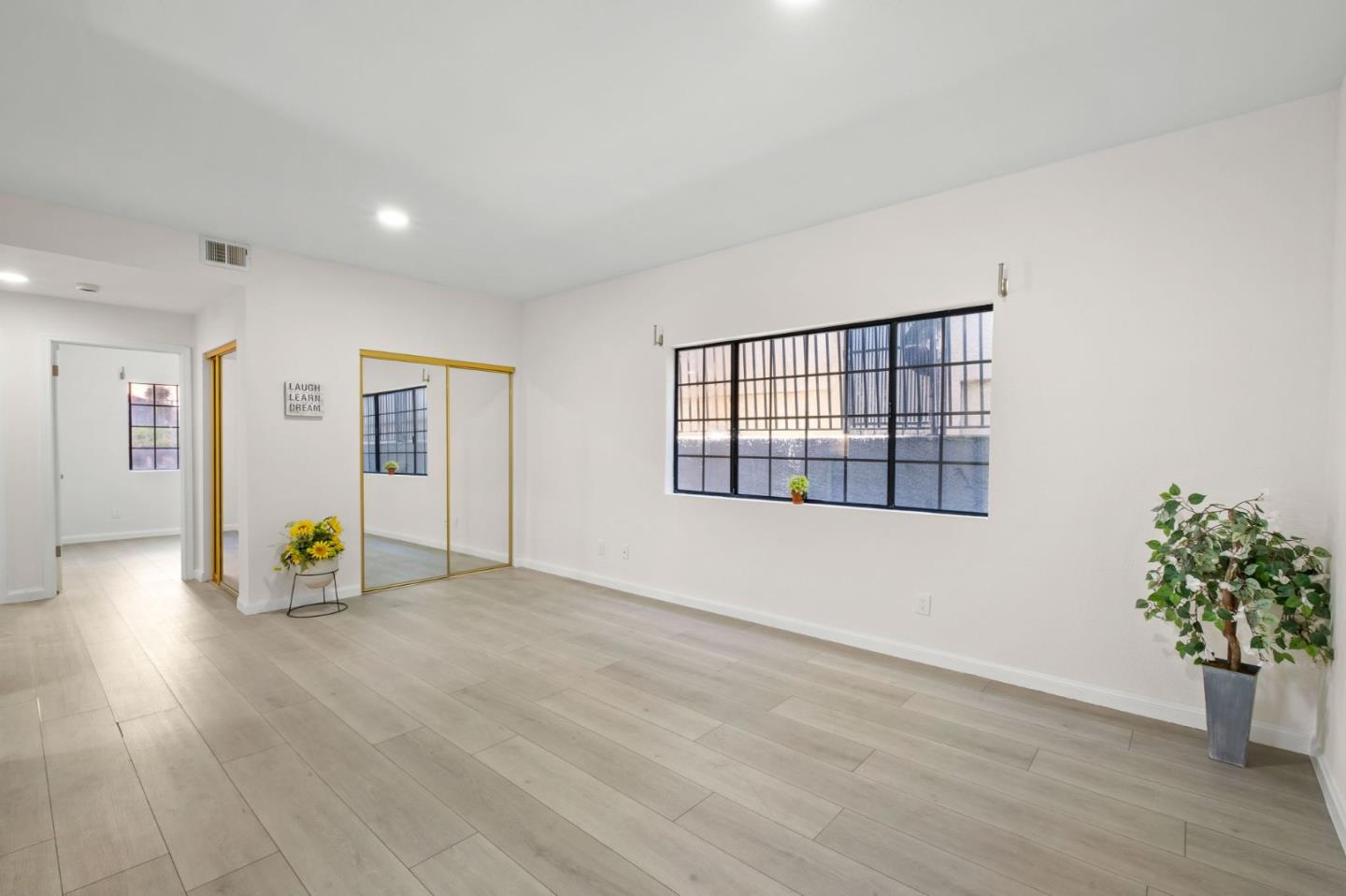 415 C Street Colma, CA 94014 - Photo 39 of 57 a view of an empty room with wooden floor and a window
