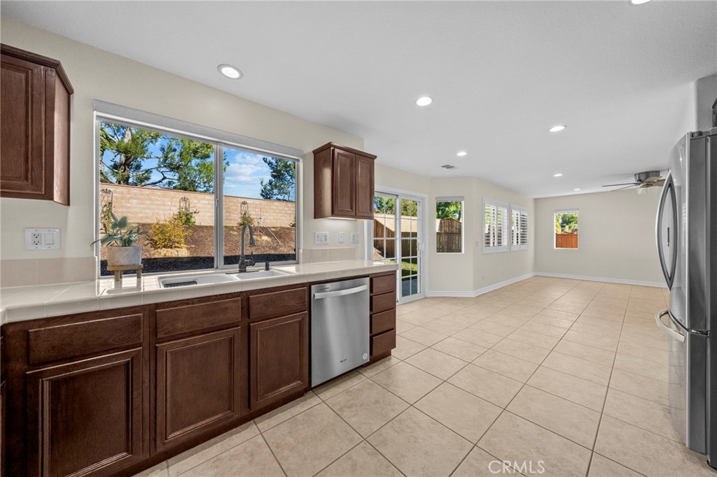 11344 Magnolia Street Corona, CA 92883 - Photo 24 of 75 a kitchen with stainless steel appliances granite countertop a refrigerator and a sink