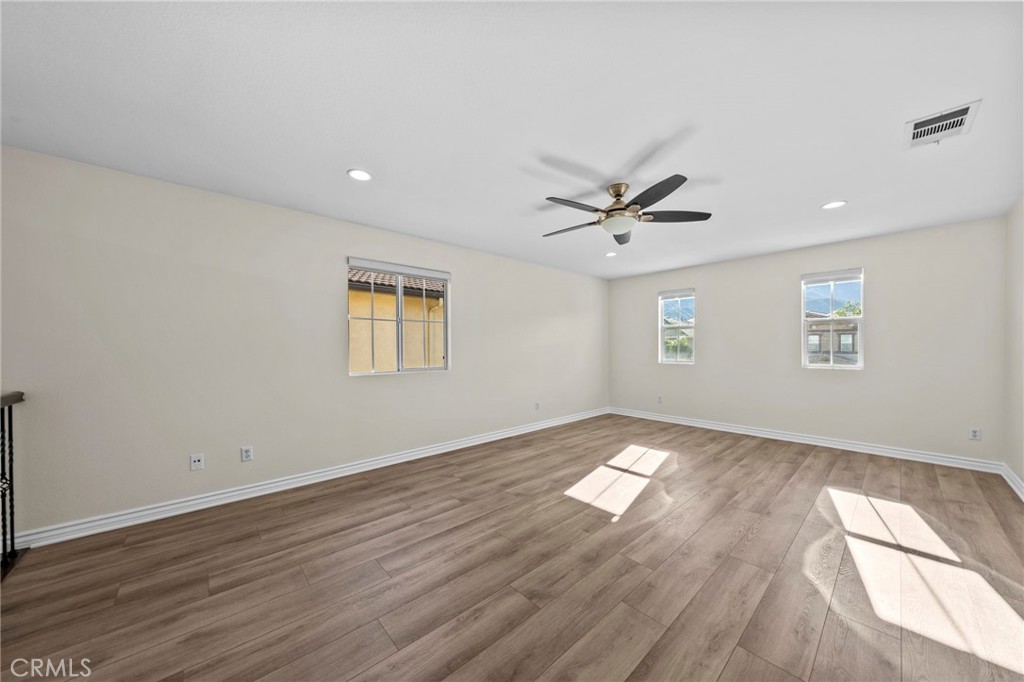11344 Magnolia Street Corona, CA 92883 - Photo 30 of 75 an empty room with wooden floor and windows