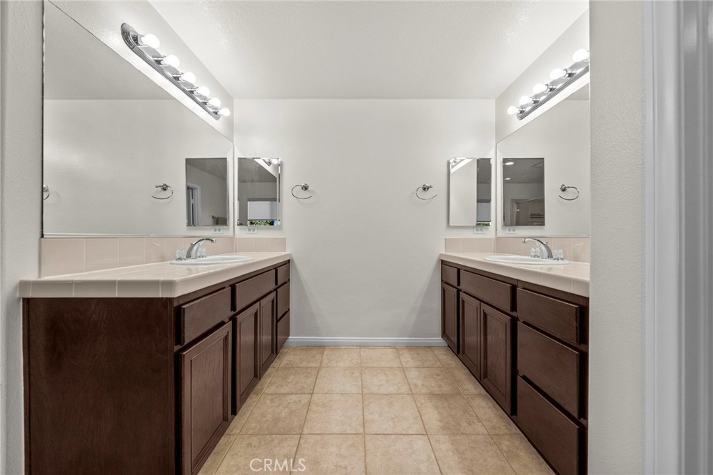 11344 Magnolia Street Corona, CA 92883 - Photo 39 of 75 a bathroom with a sink double vanity and a mirror