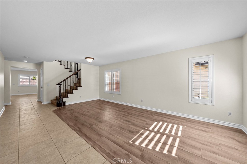 11344 Magnolia Street Corona, CA 92883 - Photo 6 of 75 a view of an empty room with wooden floor and a window