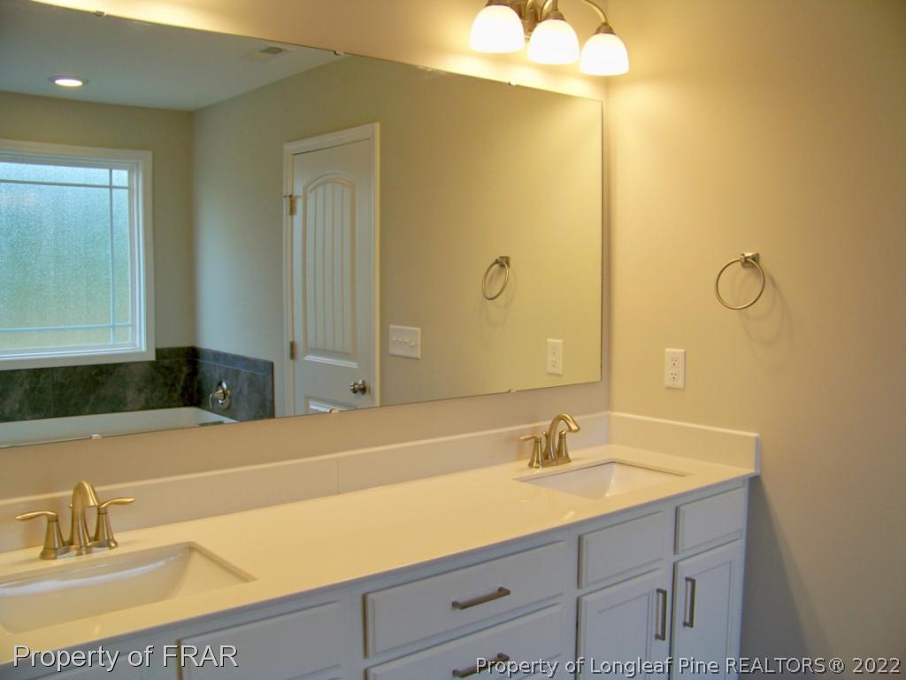 160 Cashew Loop Carthage, NC 28326 - Photo 13 of 16 a bathroom with a sink and a mirror