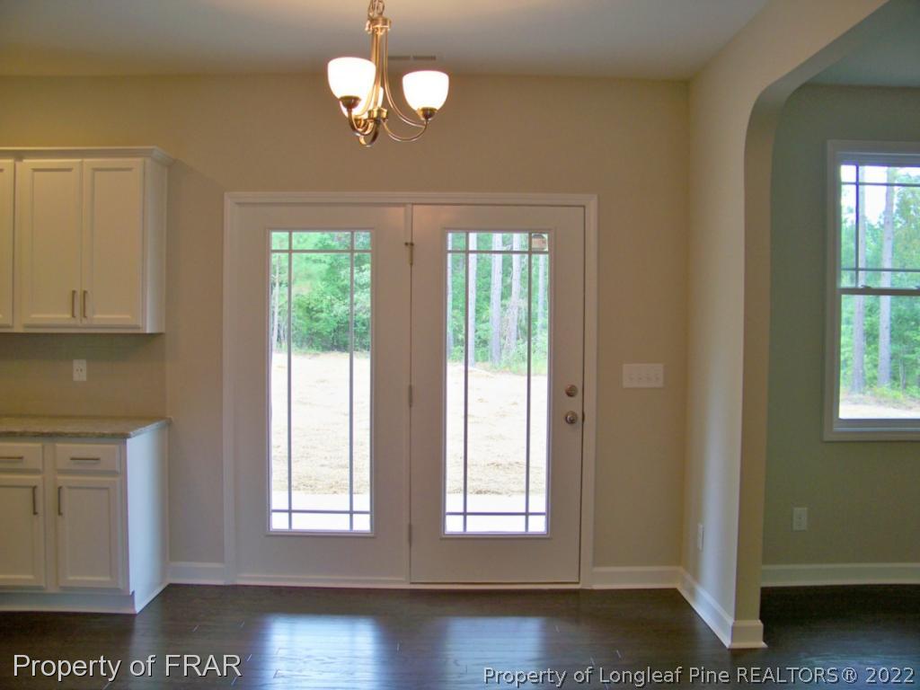 160 Cashew Loop Carthage, NC 28326 - Photo 5 of 16 a view of an empty room with a window and wooden floor