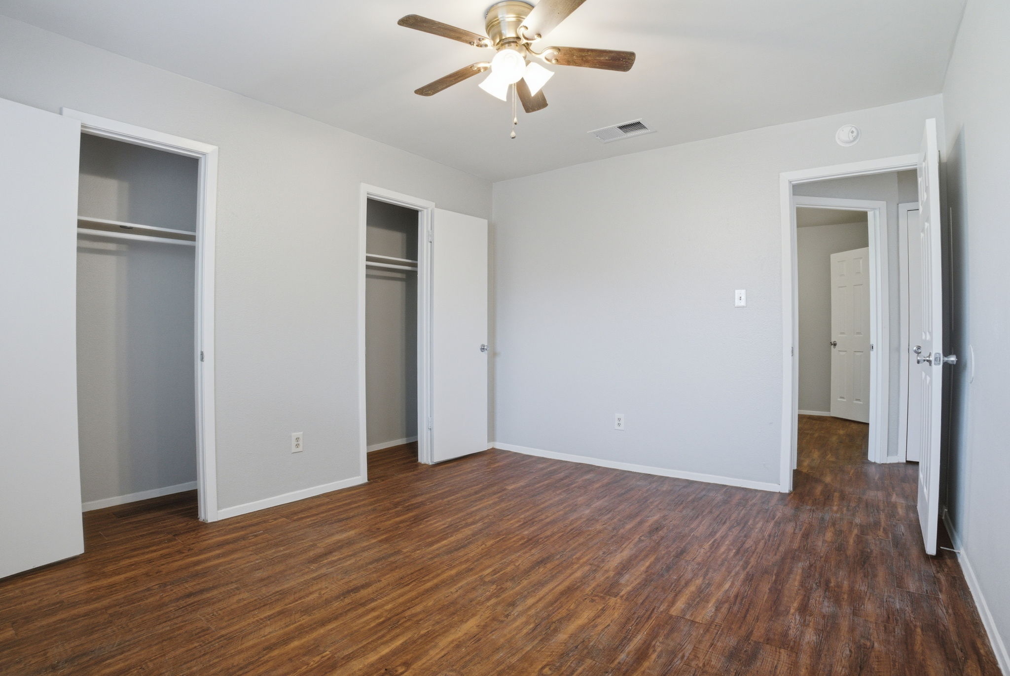 5204 Nuckols Crossing Road, Unit B Austin, TX 78744 - Photo 4 of 16 an empty room with wooden floor closet and windows
