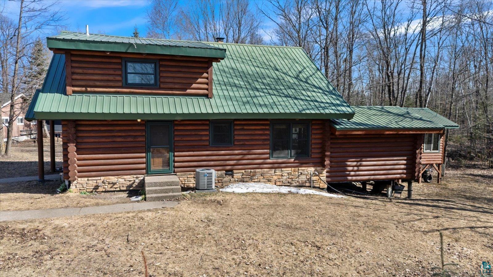 717 Bourgin Road Virginia, MN 55792 - Photo 45 of 47 Log-style house with log exterior, metal roof, and central air condition unit