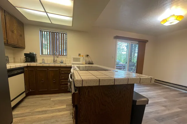 a kitchen with a sink a refrigerator and cabinets